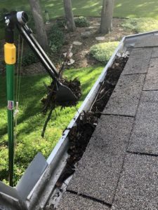 Gutter Sense tongs grabbing gutter gunk