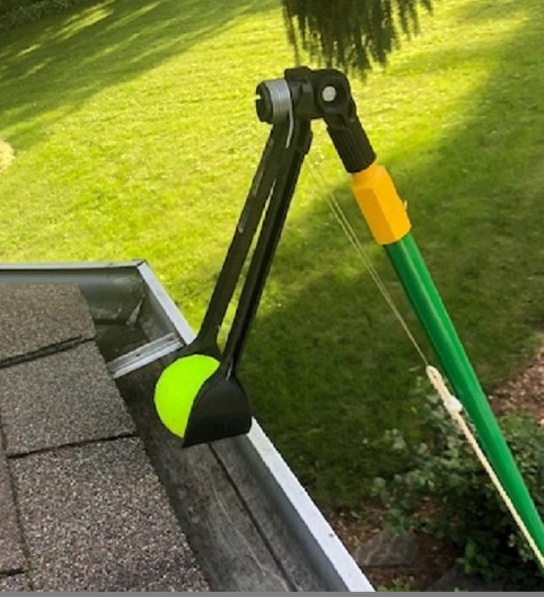 Gutter cleaning tongs grabbing tennis ball